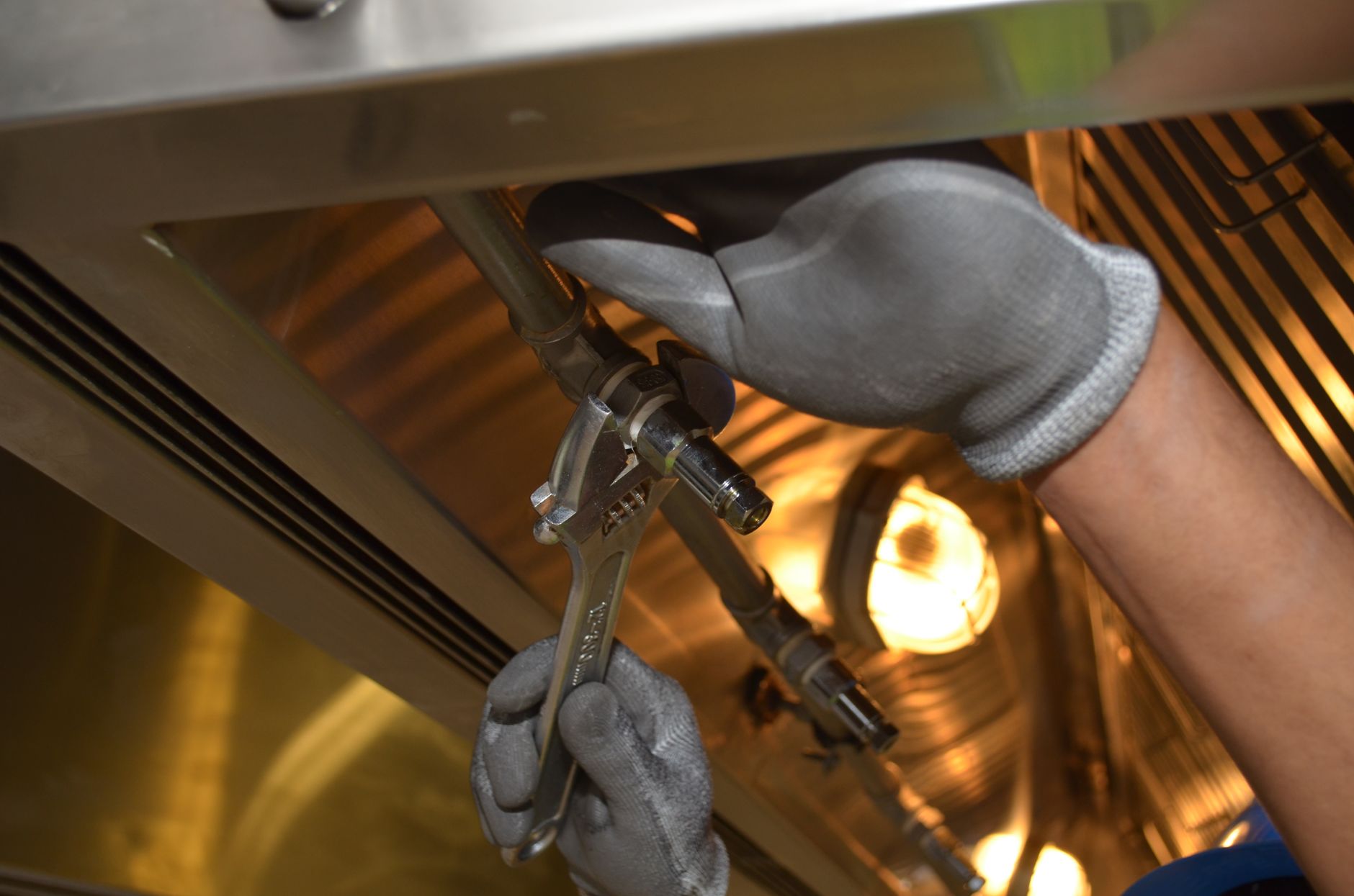 plumber working beneath kitchen sink