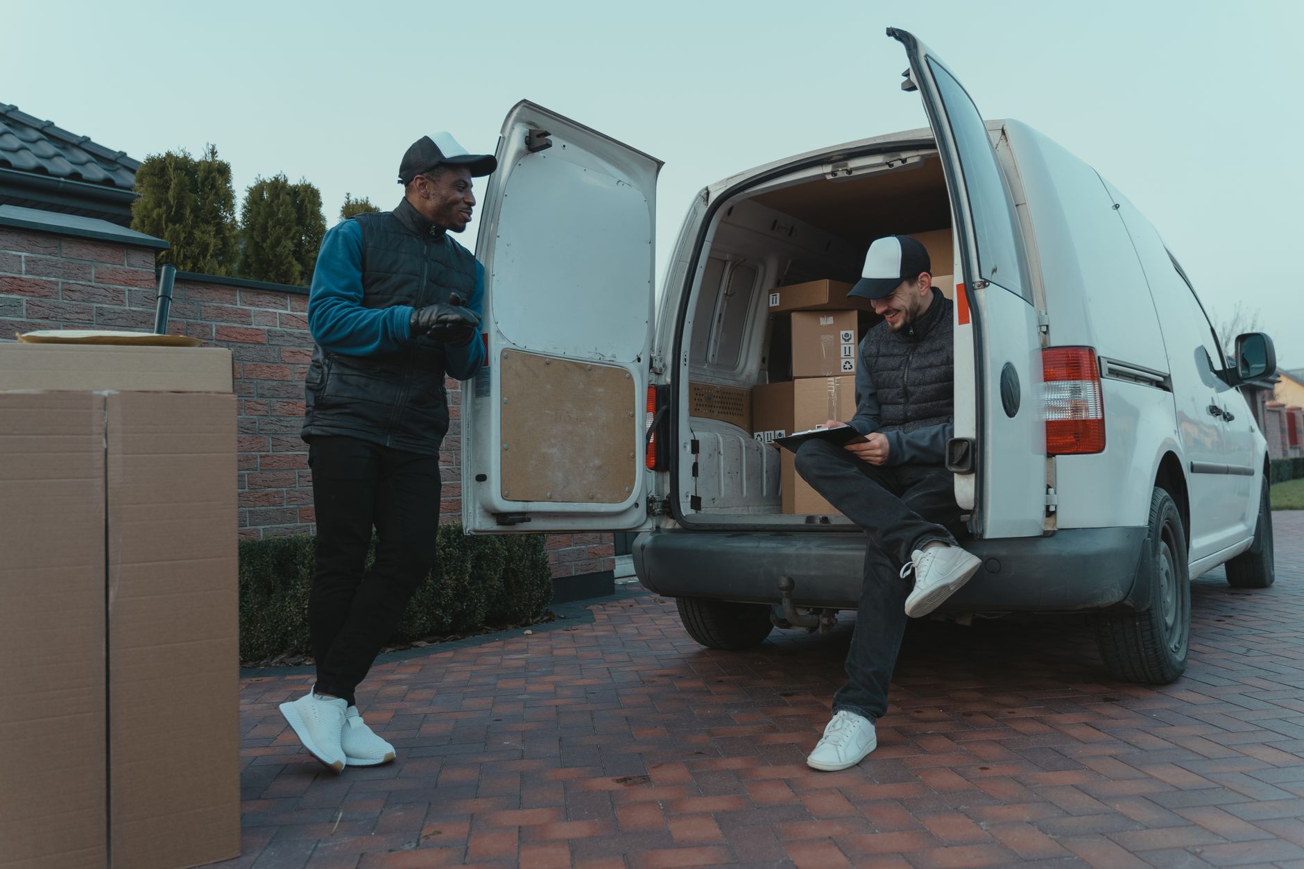 plumbers standing beside service van