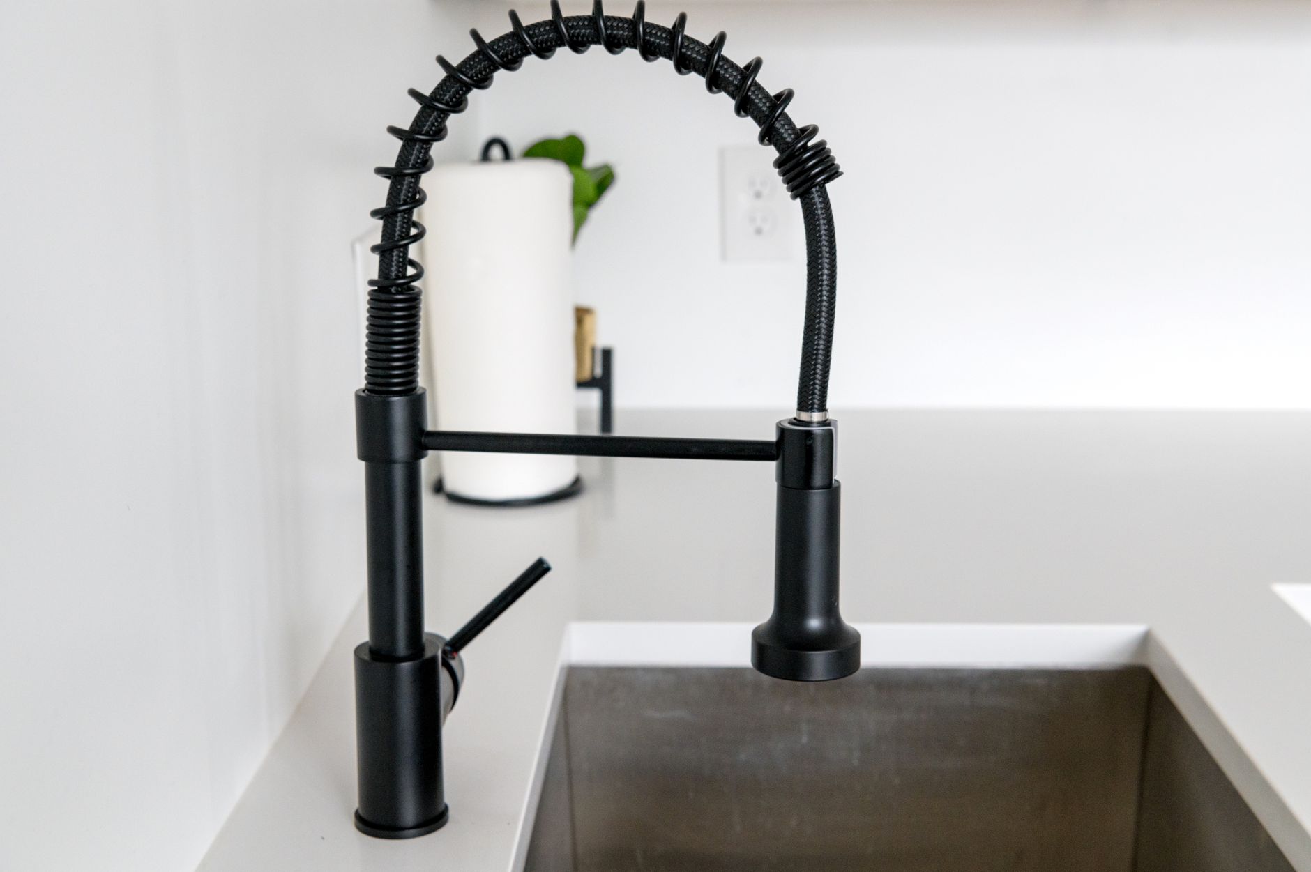 plumber repairing kitchen pipe